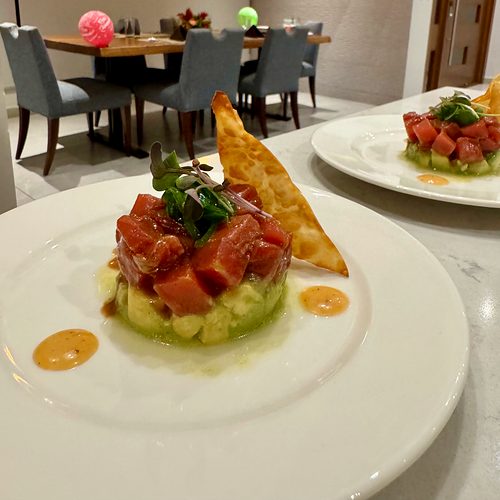 Tuna tartare over avocado, a plated first course