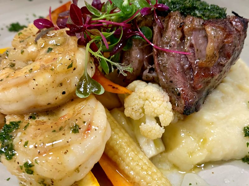 Shrimp and grilled steak with vegetables, plated in a villa in Ocotal